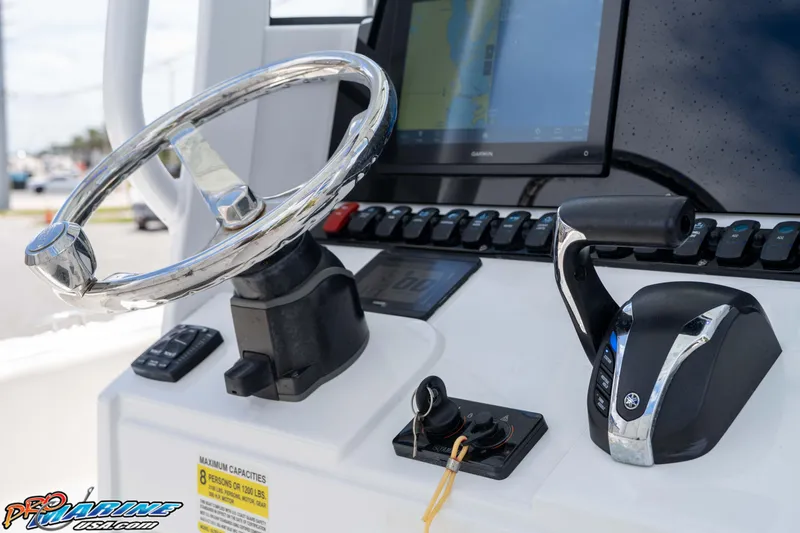 Slide: The Image of Steering console of 2023 Sea Hunt Ultra 239 SE boat with controls and display. - 31