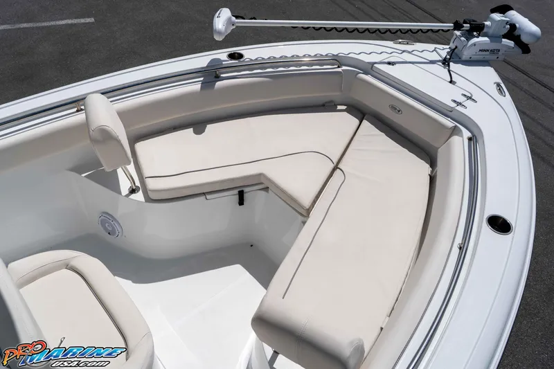 Slide: The Image of 2023 Sea Hunt Ultra 239 SE boat with cushioned seating and trolling motor. - 34