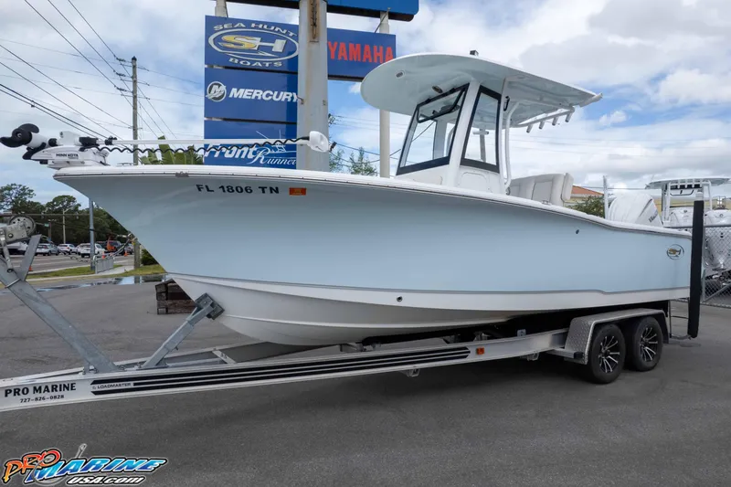 Slide: The Image of 2023 Sea Hunt Ultra 239 SE boat on trailer at dealership, featuring sleek design. - 37