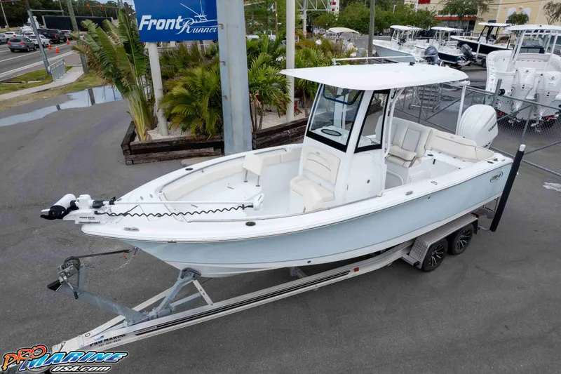 Slide: The Image of 2023 Sea Hunt Ultra 239 SE boat on trailer at dealership, featuring sleek design. - 39