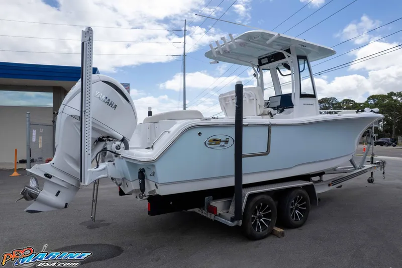 Slide: The Image of 2023 Sea Hunt Ultra 239 SE boat on trailer with Yamaha engine, parked outdoors. - 44