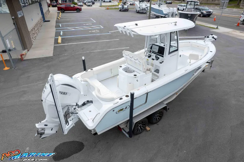 Slide: The Image of 2023 Sea Hunt Ultra 239 SE boat on trailer, featuring Yamaha engine, parked outdoors. - 45