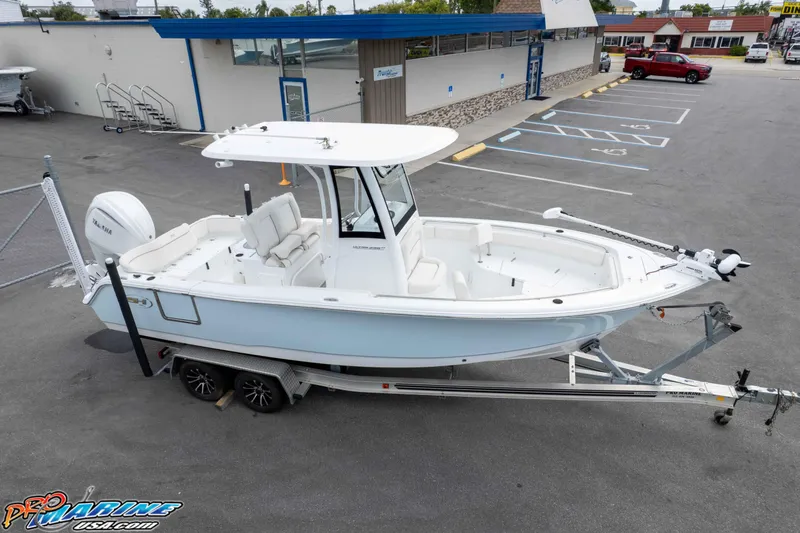 Slide: The Image of 2023 Sea Hunt Ultra 239 SE boat on trailer in parking lot. - 46