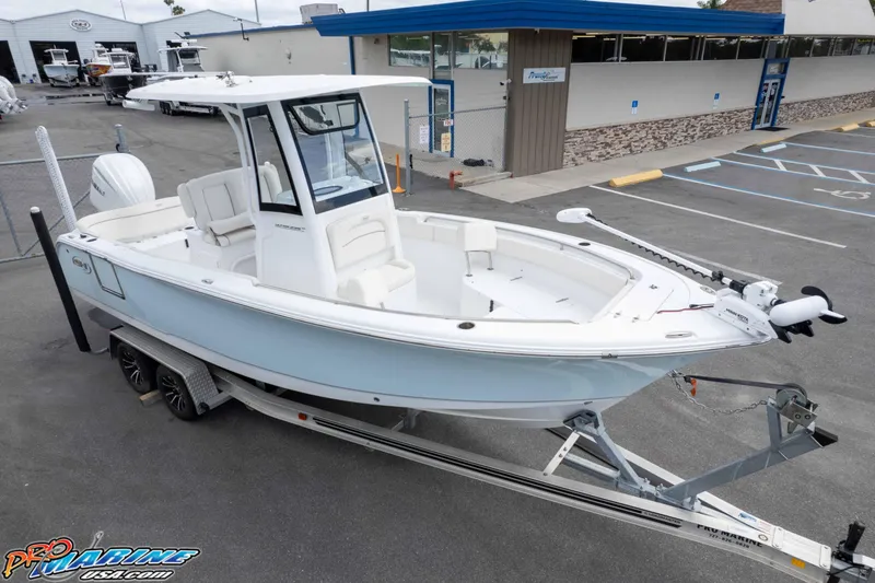Slide: The Image of 2023 Sea Hunt Ultra 239 SE boat on trailer in parking lot. - 47