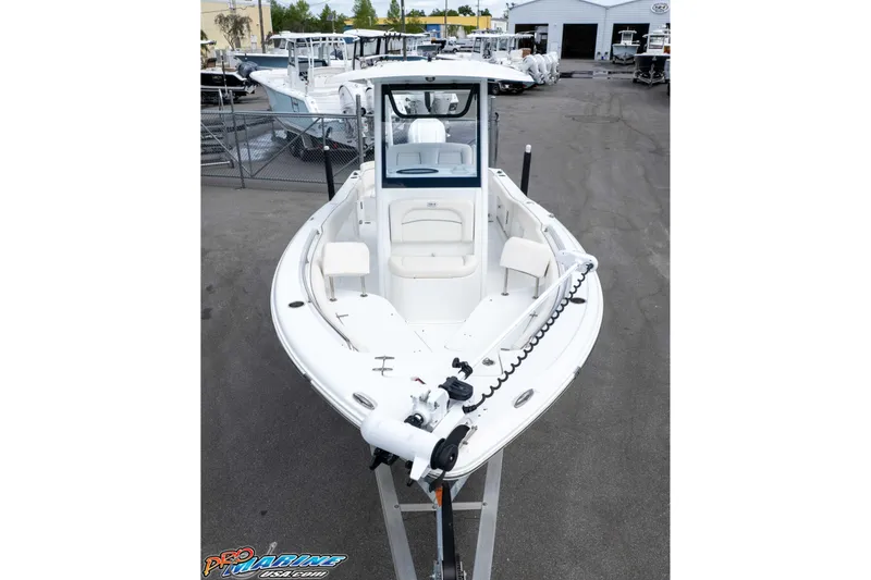 Slide: The Image of 2023 Sea Hunt Ultra 239 SE boat displayed at a dealership, showcasing sleek design. - 48