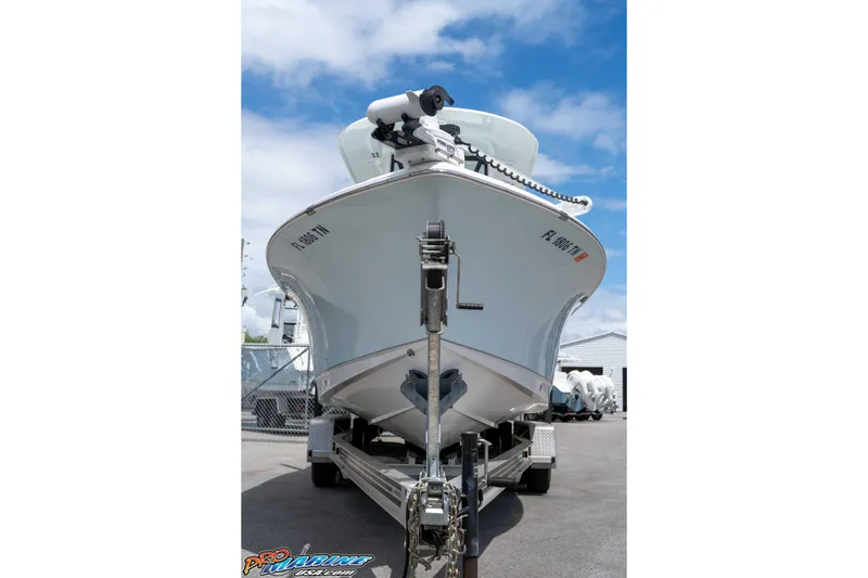 Slide: The Image of 2023 Sea Hunt Ultra 239 SE boat on trailer, viewed from front under a blue sky. - 7