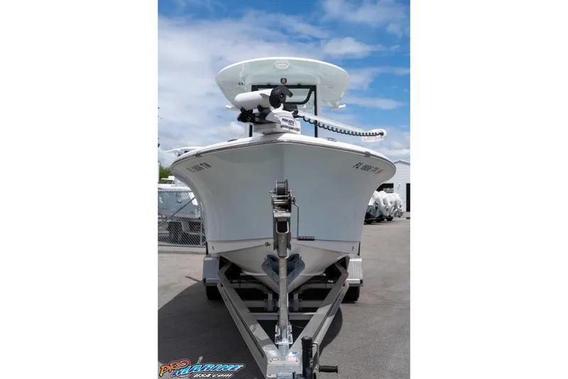 Slide: The Image of 2023 Sea Hunt Ultra 239 SE boat on trailer, parked outdoors under blue sky. - 8
