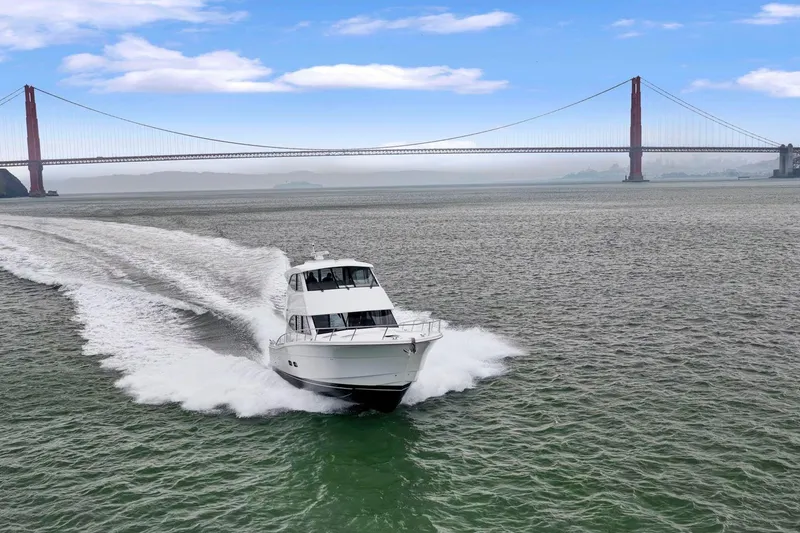 Slide: The Image of 2014 Maritimo M50 yacht cruising near Golden Gate Bridge under blue sky. - 1