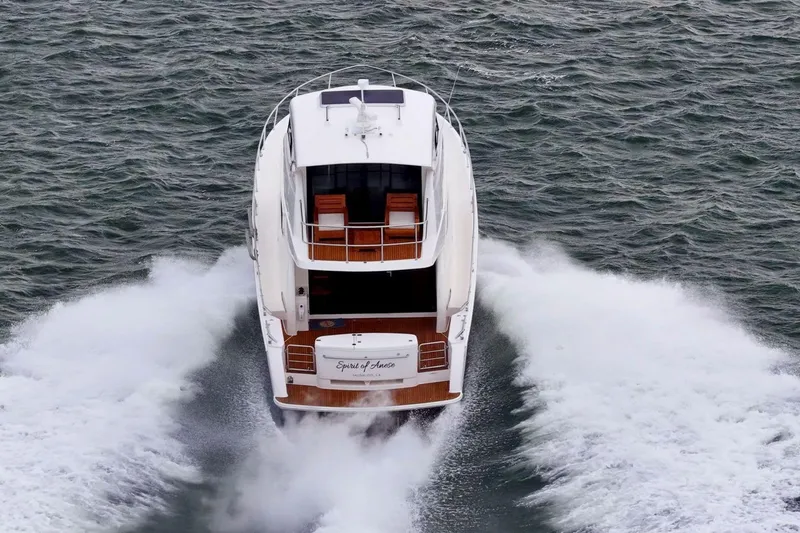 Slide: The Image of 2014 Maritimo M50 yacht cruising on open water, rear view. - 17