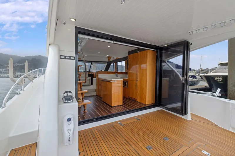 Slide: The Image of 2014 Maritimo M50 yacht interior with open sliding doors and wooden flooring. - 30