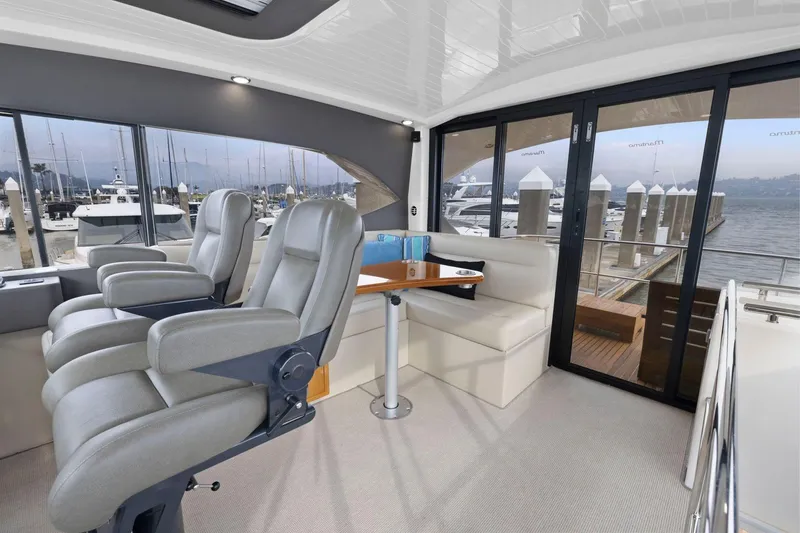 Slide: The Image of Luxurious interior of 2014 Maritimo M50 yacht with plush seating and marina view. - 50