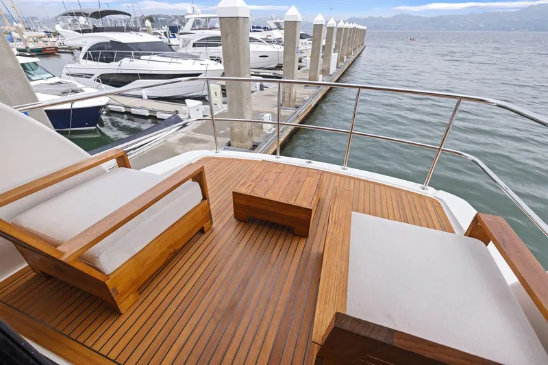 Slide: The Image of Luxury Maritimo M50 yacht deck with wooden seating, docked at marina, 2014 model. - 54