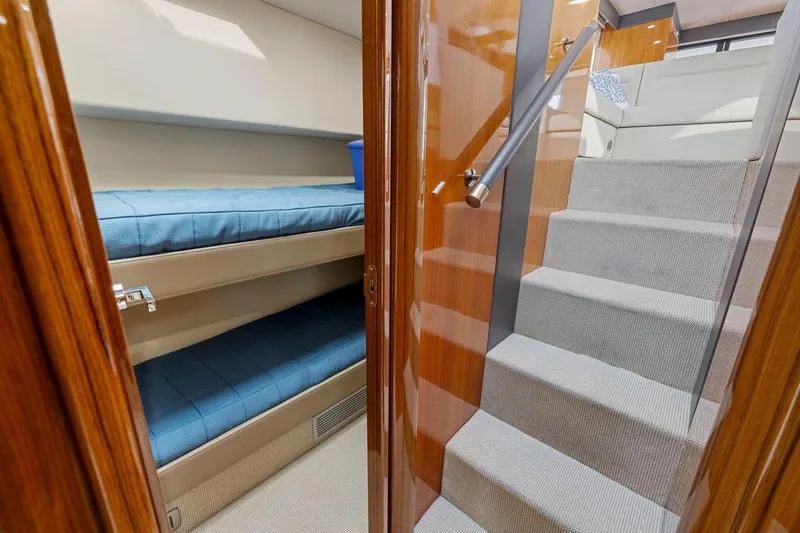 Slide: The Image of Interior of 2014 Maritimo M50 yacht featuring bunk beds and carpeted stairs. - 65