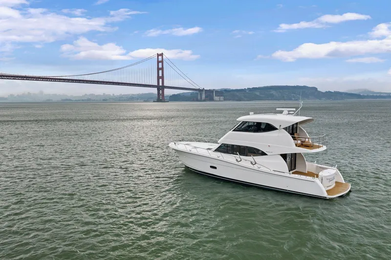 Slide: The Image of 2014 Maritimo M50 yacht cruising near iconic bridge on a clear day. - 9