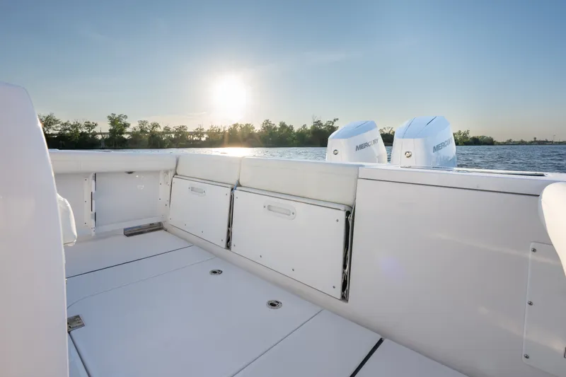 Slide: The Image of 2026 Everglades 335 Center Console boat with twin Mercury engines at sunset. - 18