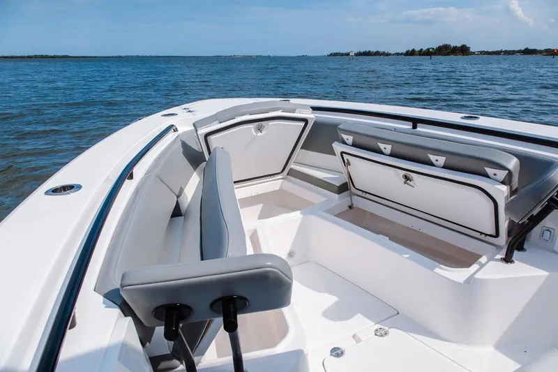 Slide: The Image of 2026 Everglades 335 Center Console boat interior with seating and storage, on calm water. - 11