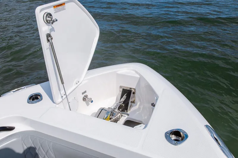 Slide: The Image of 2026 Everglades 335 Center Console boat anchor compartment open on water. - 12