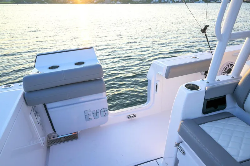 Slide: The Image of Manufacturer Provided Image: 2026 Everglades 335 Center Console boat interior with sunset view over water. - 15