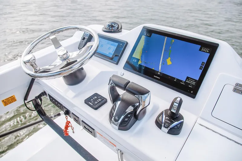 Slide: The Image of Manufacturer Provided Image: 2026 Everglades 335 Center Console boat dashboard with navigation screens and controls. - 17