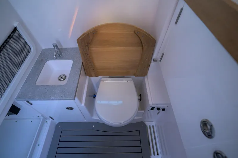Slide: The Image of Interior of 2026 Everglades 335 Center Console boat bathroom with sink and toilet. - 21