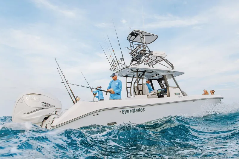 Slide: The Image of Manufacturer Provided Image: 2026 Everglades 335 Center Console boat navigating ocean waves, featuring fishing rods and Yamaha engine. - 3