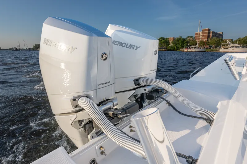 Slide: The Image of Twin Mercury Verado engines on 2026 Everglades 335 Center Console boat, cruising on water. - 8