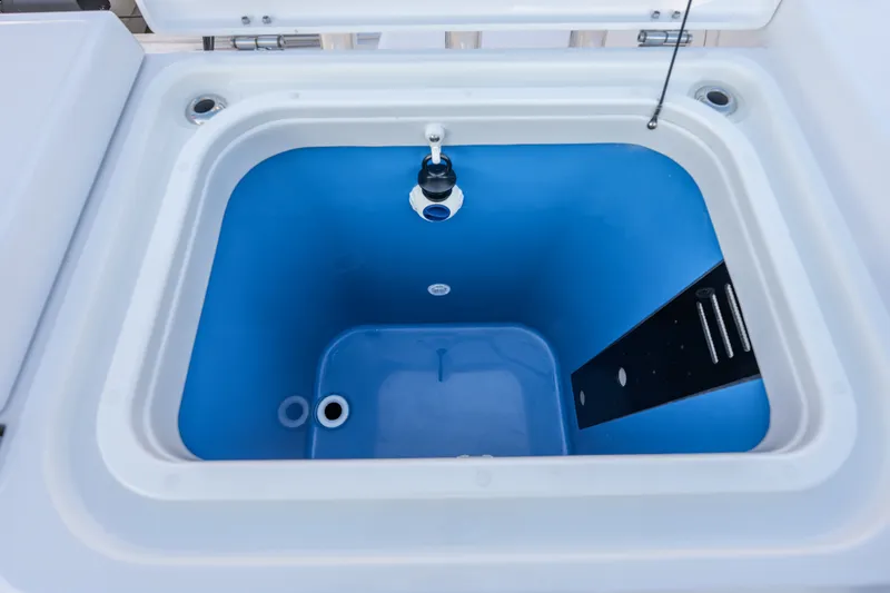 Slide: The Image of Livewell compartment on 2026 Everglades 335 Center Console boat, featuring a blue interior. - 29