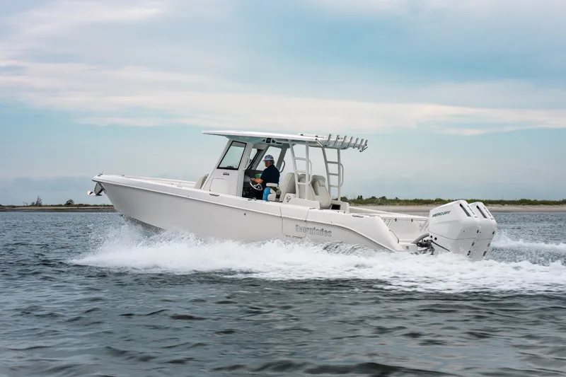 Slide: The Image of 2026 Everglades 335 Center Console boat cruising on open water. - 4