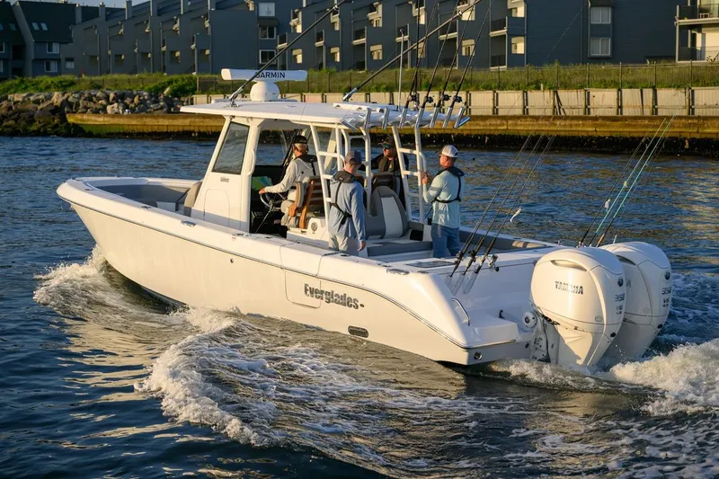 Slide: The Image of 2026 Everglades 335 Center Console boat cruising with anglers on board. - 6