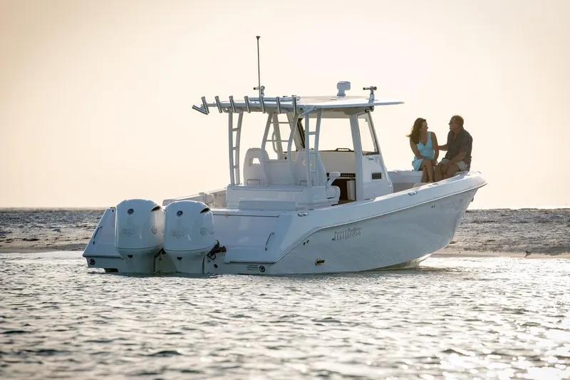 Slide: The Image of 2026 Everglades 335 Center Console boat on water with two people seated. - 7