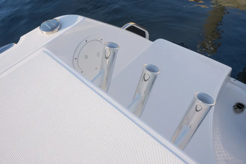 Slide: The Image of Everglades 335 Center Console 2026 boat deck with rod holders and water reflection. - 28