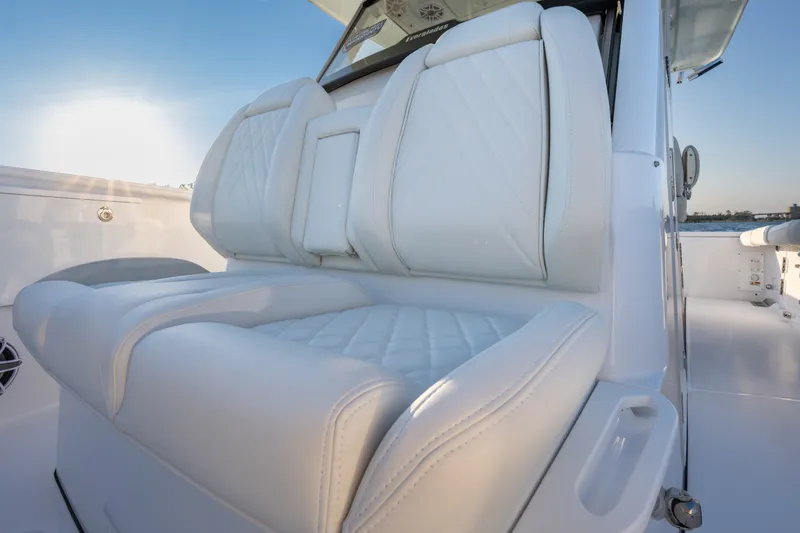 Slide: The Image of Luxurious seating on 2026 Everglades 335 Center Console boat, featuring elegant white upholstery. - 16