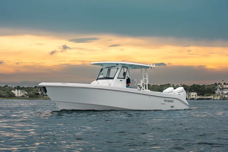 Slide: The Image of 2026 Everglades 335 Center Console boat on water at sunset. - 5