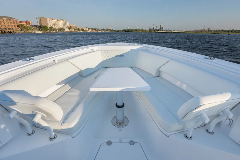 Slide: The Image of 2026 Everglades 335 Center Console boat with spacious seating and table on calm waters. - 17