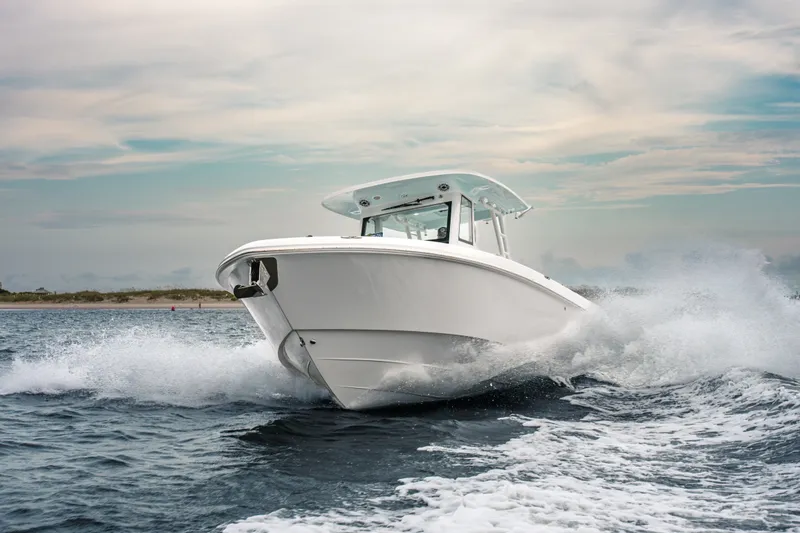 Slide: The Image of 2026 Everglades 335 Center Console boat navigating through ocean waves. - 7