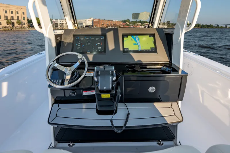 Slide: The Image of 2026 Everglades 335 Center Console boat dashboard with navigation display on open water. - 12