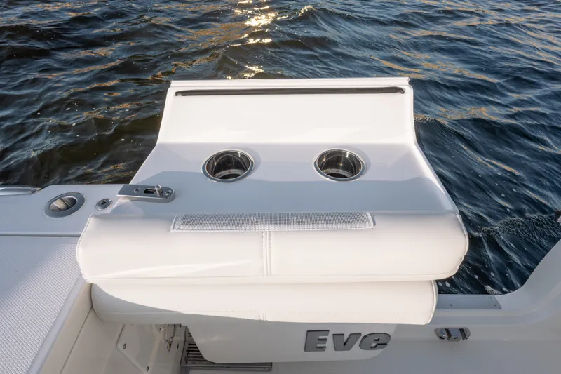 Slide: The Image of 2026 Everglades 335 Center Console boat with sleek white seating and cup holders on water. - 22