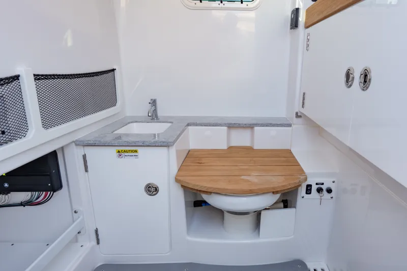 Slide: The Image of Interior of 2026 Everglades 335 Center Console boat with sink and wooden seat. - 30