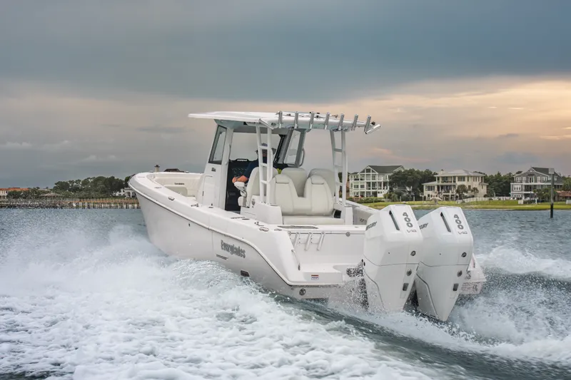 Slide: The Image of 2026 Everglades 335 Center Console boat cruising on water with dual engines. - 3
