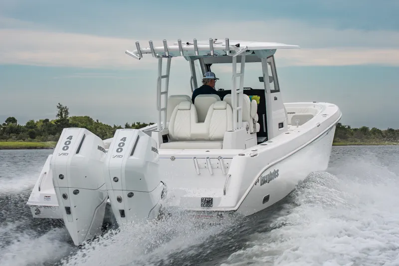 Slide: The Image of 2026 Everglades 335 Center Console boat cruising with twin Mercury 400 engines. - 2
