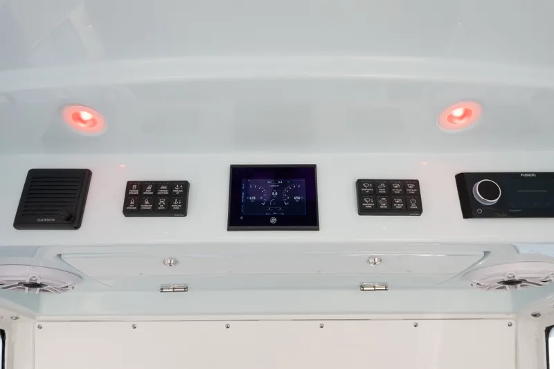 Slide: The Image of Control panel of 2026 Everglades 335 Center Console boat with modern navigation equipment. - 14