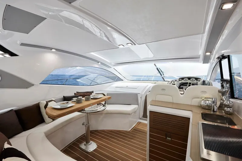 Slide: The Image of Luxurious interior of 2024 Sessa Marine C44 Cruiser with elegant seating and dining area. - 3