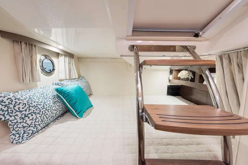 Slide: The Image of Manufacturer Provided Image: 2018 Regal 28 Express cabin interior with bed, pillows, and wooden ladder. - 14