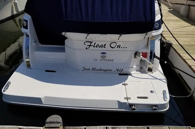 Slide: The Image of 2018 Regal 28 Express boat docked, named "Float On," in Port Washington, NY. - 2