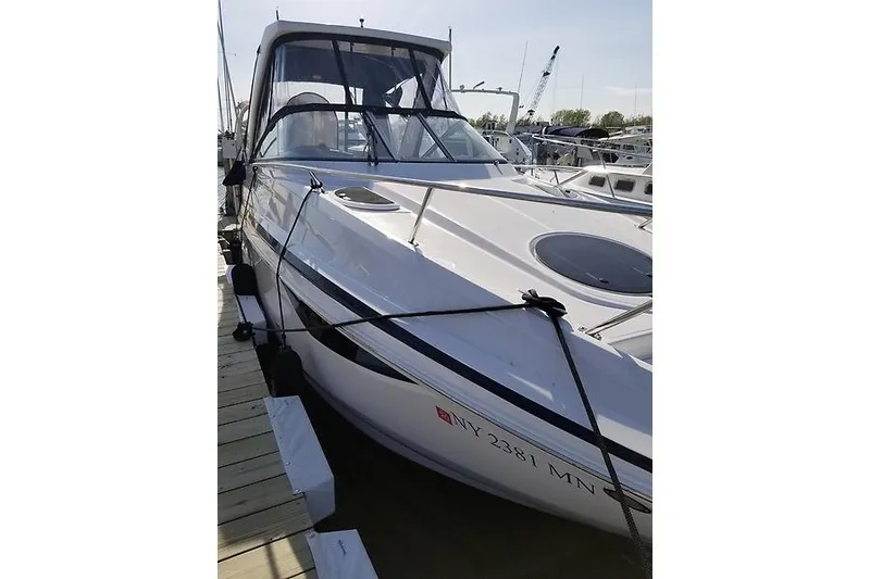 Slide: The Image of 2018 Regal 28 Express boat docked at marina, side view. - 4