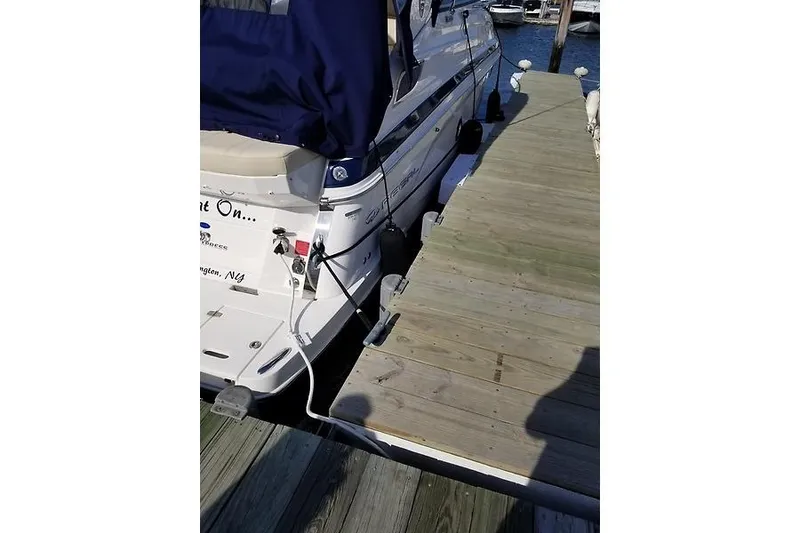 Slide: The Image of 2018 Regal 28 Express boat docked at a wooden pier. - 5