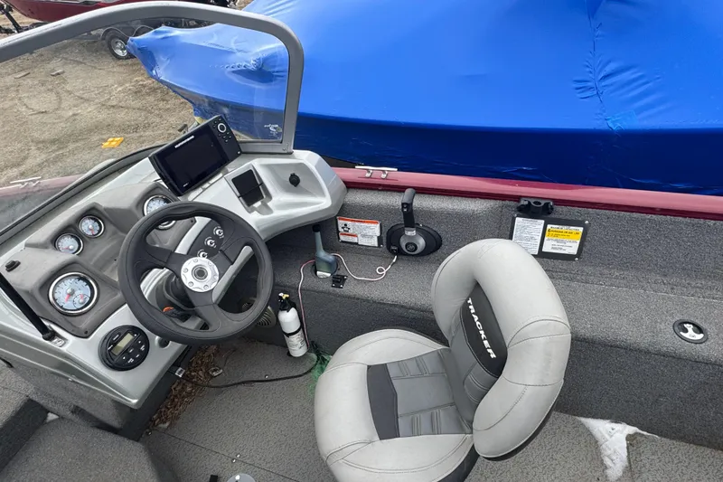 Slide: The Image of 2018 Tracker Pro Guide V-175 Combo boat interior with steering wheel and dashboard controls. - 7