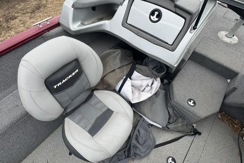 Slide: The Image of 2018 Tracker Pro Guide V-175 Combo boat interior with gray seating and storage compartments. - 8