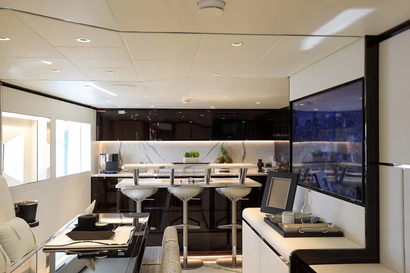 Slide: The Image of Luxurious interior of 2025 Majesty 120 yacht with modern bar and seating area. - 35