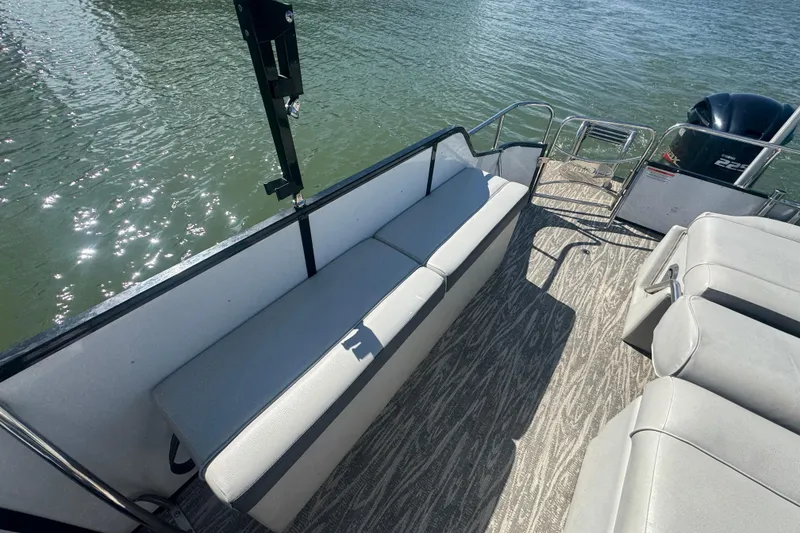 Slide: The Image of 2020 SunCatcher Elite 326 DLX SS pontoon boat interior with seating and water view. - 14